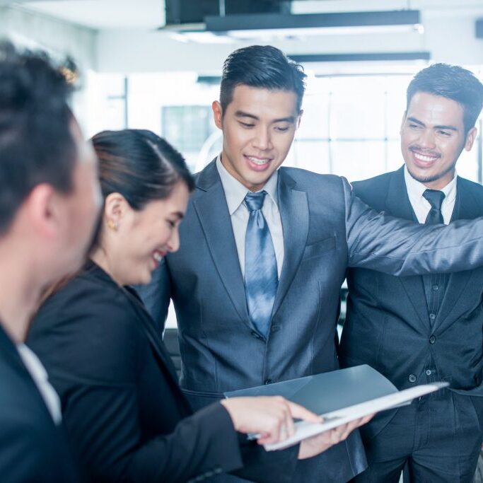 Young Asian business people at work.